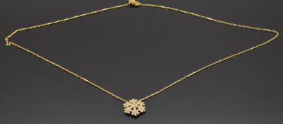 A 14ct gold necklace in the form of a snowflake set with cubic zirconia, 2.3g