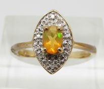 A 9ct gold ring set with an oval cut Indonesian opal and diamonds, 2.4g, size N