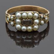 Victorian mourning ring set with hair to the centre surrounded by seed pearls, size O, 2.00g