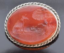 Victorian silver brooch set with a carved carnelian agate panel depicting a dog and a hare, 2.5 x