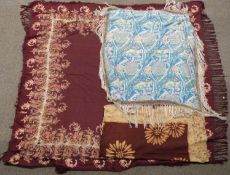A 19th/20thC burgundy shawl with floral decoration and fringe border and two printed silk shawls,