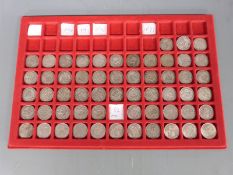 A collection of over sixty UK shillings 1911 through to 1966