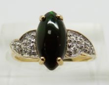 A 9ct gold ring set with a marquise cut Mezezo opal cabochon and zircons, 2.4g, size N