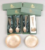 Four cased hallmarked silver teaspoons and two feature hallmarked silver pin dishes, weight 187g