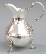 Victorian hallmarked silver jug, raised on three feet, London 1868 maker Richards & Brown, height