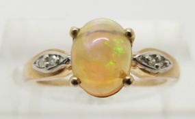 A 9ct gold ring set with an opal cabochon and diamonds, 1.8g, size J