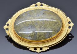 Victorian yellow metal brooch set with a gold veined quartz cabochon within an engraved border, 5.
