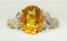 A 9ct gold ring set with an oval fire opal and diamonds, 2.4g, size N