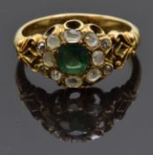 An early Victorian ring set with a cushion cut emerald of approximately 0.5ct surrounded by old
