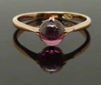 An early 20thC 9ct gold ring set with a garnet cabochon, size P/Q, 1.93g