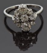 A platinum ring set with old mine cut diamonds measuring approximately 0.55, 0.48, 0.2, 0.15, 0.