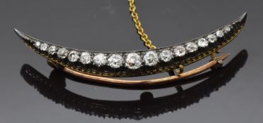 Victorian crescent brooch set with graduated old cut diamonds, 4.8cm long