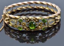 Edwardian 9ct rose gold rope twist bangle set with garnet doublets and seed pearls amongst floral