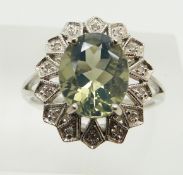 A 9ct white gold ring set with an oval cut green fire opal and diamonds, 3.5g, size N
