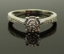 An 18ct gold ring set with diamonds in a cluster and further diamonds to the shoulders, size K/L,