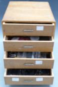 Four drawer clock repairer's cabinet containing parts and some tools, H32 x W26 x D30cm