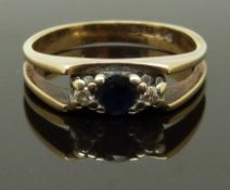 A 9ct gold ring set with a sapphire and diamonds, size J, 2.45g