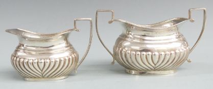 Hallmarked silver sugar bowl and milk jug with reeded lower bodies and gadrooned edge, Birmingham,