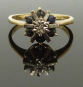 A 9ct gold ring set with sapphires and a diamond, size L, 2.17g