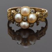 An early Victorian ring set with split pearls and old cut diamonds with engraved decoration to the