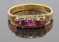 Victorian 15ct gold ring set with foiled rubies and garnets, with an engraved band, size O