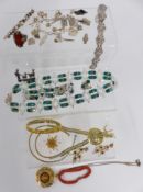 A collection of jewellery including silver brooch, silver charm bracelet, paste bracelet, silver
