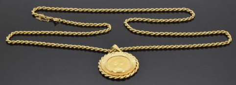 A 1958 gold full sovereign in yellow metal mount (18.1g) on 18ct gold rope twist chain (25g)