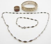 A silver bangle with applied decoration, Art Deco style ring and silver necklace with matching