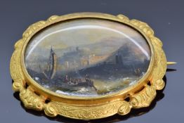 Victorian pinchbeck brooch set with a painted mother of pearl plaque depicting a seascape, 5 x 4.2cm