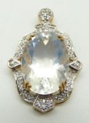 A 9ct gold pendant set with an oval cut ice opal and zircon, 6.9g