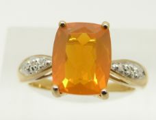 A 9ct gold ring set with a cushion cut fire opal and diamonds, 3.2g, size N