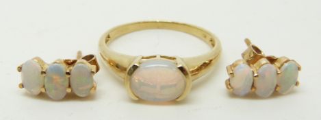 A 9ct gold ring set with an oval opal cabochon (size M/N) and a pair of earrings set with three oval