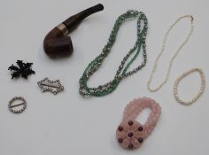 A large collection of costume jewellery including beads, bangles, brooches, rose quartz necklace,