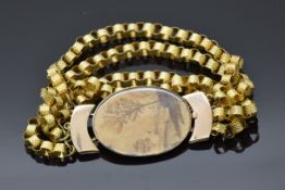 Victorian bracelet with a yellow metal clasp set with a landscape scene made from hair
