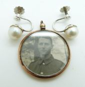 A pair of 9ct white gold earrings set with a pearl to each and an Edwardian locket with 9ct gold