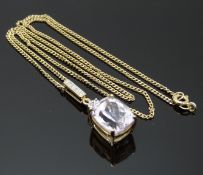 A 9ct gold pendant set with an oval mixed cut morganite and diamonds on a 9ct gold chain, 6.2g