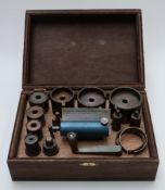 A clock spring winding tool set in wooden case