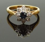 An 18ct gold ring set with a sapphire and diamonds in a flower setting, size J, 3.33g