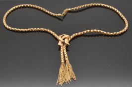 An 18k rose gold designer necklace in a knot design with tassel decoration, 22.8g