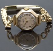 Winegartens 9ct gold ladies wristwatch with gold hands and Arabic numerals, silver dial, octagonal
