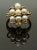 A 9ct gold ring set with pearls, size J, 5.11g