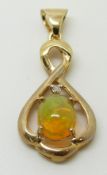A 9ct gold pendant set with an Indonesian opal and a diamond, 2.2g