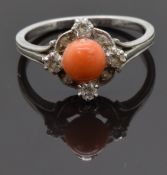 A white metal ring set with a coral cabochon and diamonds, size M, 3.54g