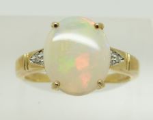 A 9ct gold ring set with an oval opal cabochon and diamonds,2.5g, size N