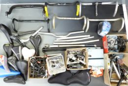 Large collection of bicycle components including saddles, saddle posts, stems, brake components etc
