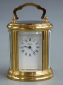 Angelus brass oval cased 20thC carriage clock with French L'Epee II jewel movement, 8cm tall
