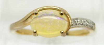 A 9ct gold ring set with an oval opal cabochon and diamonds, 2g, size N