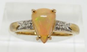 A 9ct gold ring set with a pear cut Indonesian opal and diamonds, 2.8g, size N