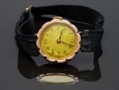 A 9ct gold ladies wristwatch with Arabic numerals, blued Breguet hands and daisy shaped case, on