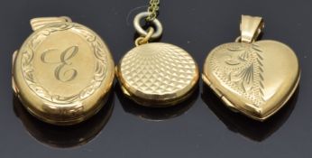 A 9ct gold locket, 9ct gold heart locket and a 9ct back and front locket with engine turned